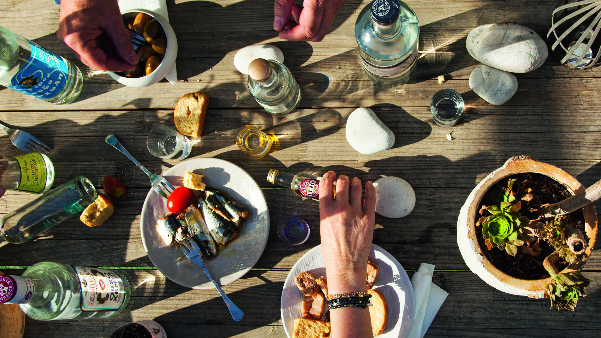 a-table-with-sea-food-ouzo-bottles-from-different-greek-companies